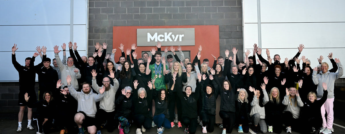 McKvr staff waving outside the McKvr building