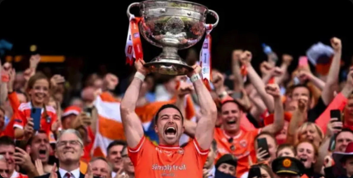 Armagh player lifting the Sam Maguire Cup among fans