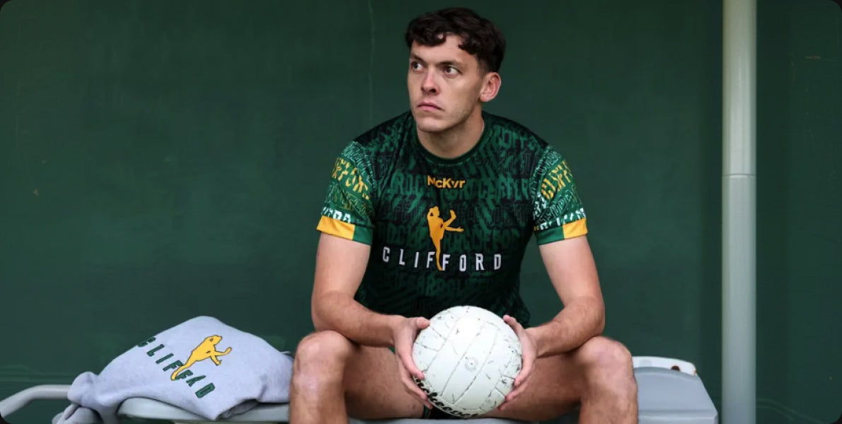GAA player in a Clifford Range jersey holding a football