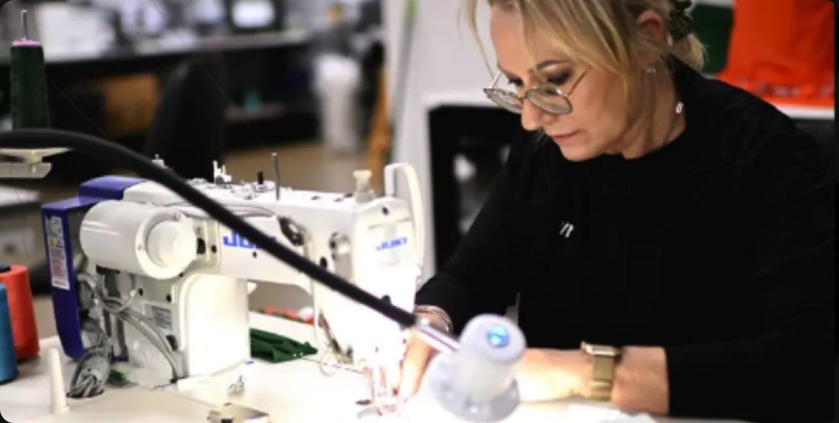Machinist sewing a garment in the McKvr factory